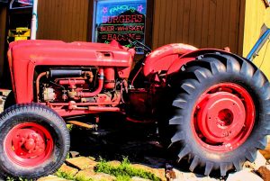 The tractor out front of Lucky 13 is a 1962 Ford 4000 Series that originally worked farms in Northern Utah for 15 years before spending another 17 years hauling boats at Bear Lake. After years of hard work and multiple repairs using Ford 801 parts, it fell into disrepair and was neglected for 12 years. In 2009, Jason Stucki and his brother restored the family tractor and drove it to Lucky 13 for the grand opening, where it quickly became a beloved fixture and unofficial greeter in its new semi-retirement.