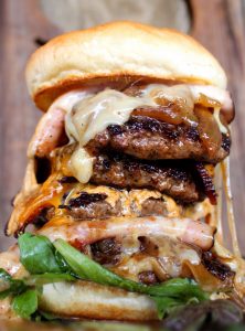 A foot tall burger With house-smoked bacon, ham, cheddar, swiss, caramelized onions, Lucky 13 sauce and 28oz of fresh ground chuck